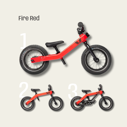 Red balance bike with black wheels on a light gray background